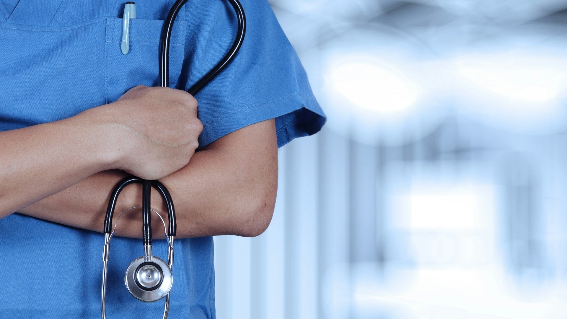 health-B-person-scrubs-stethoscope-arm